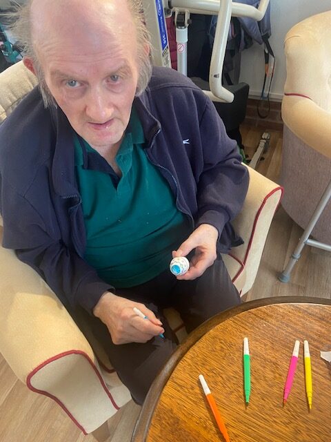 Resident decorating elements for his Easter bonnet rotated