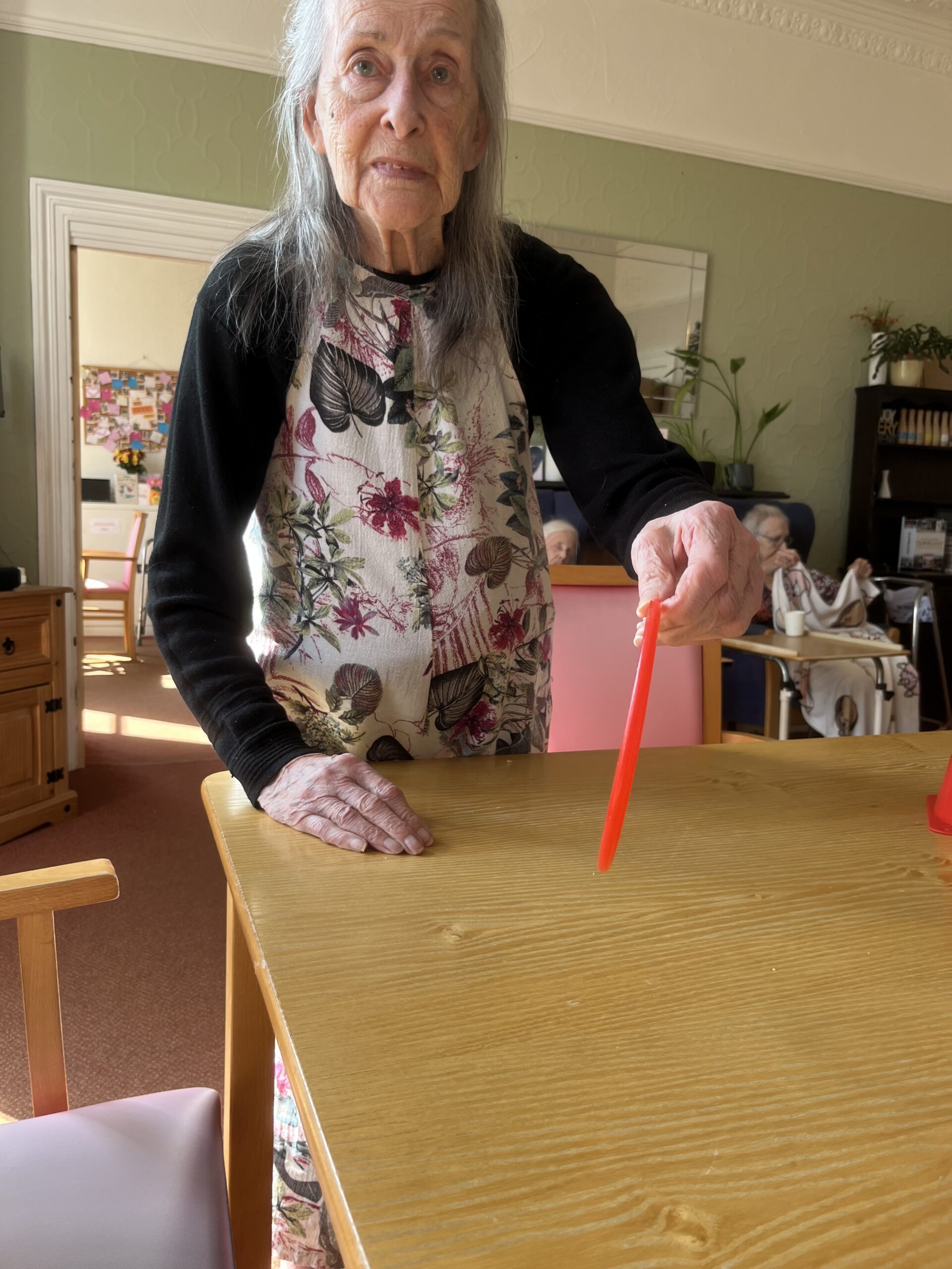 Resident throwing hoops onto cones on a table 1 scaled