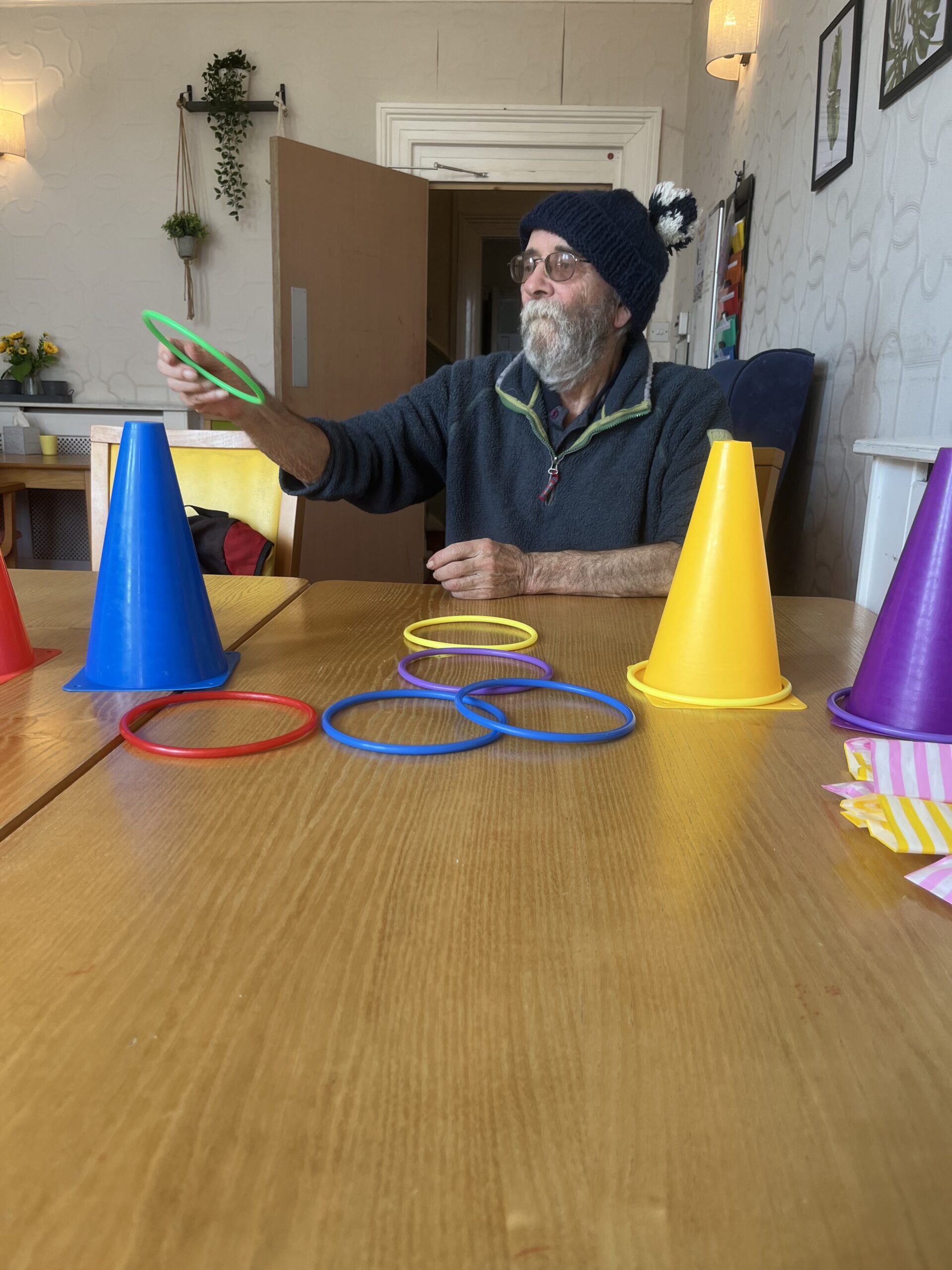 Resident throwing hoops onto cones on a table 2 scaled