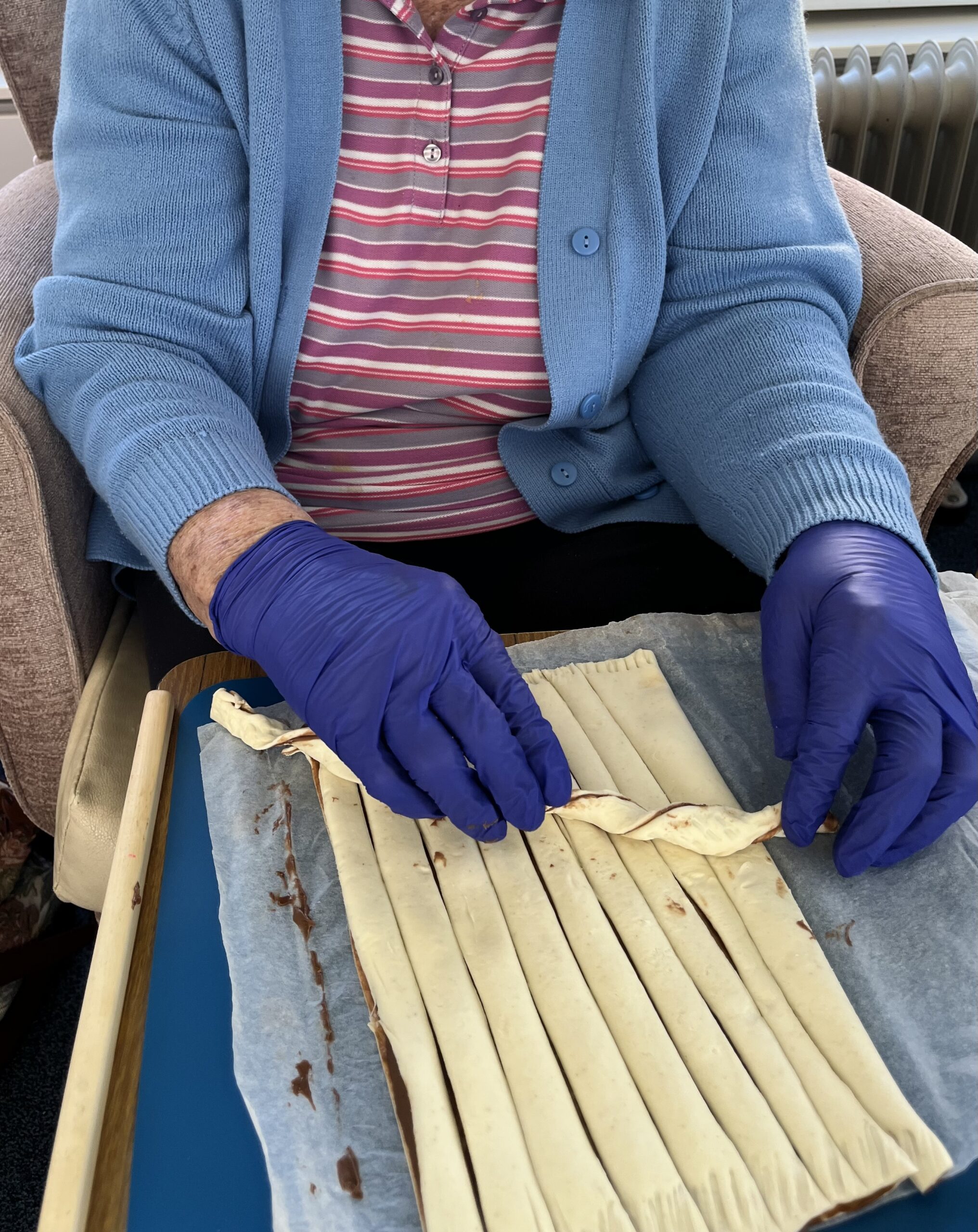 Barb rolling the pastry strips into spiral nests scaled