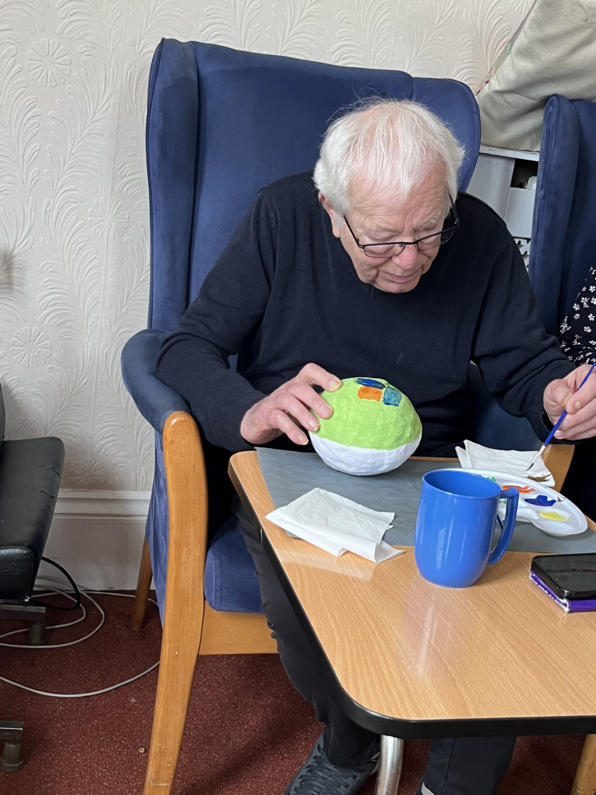 Brian decorating his Easter egg with paint scaled