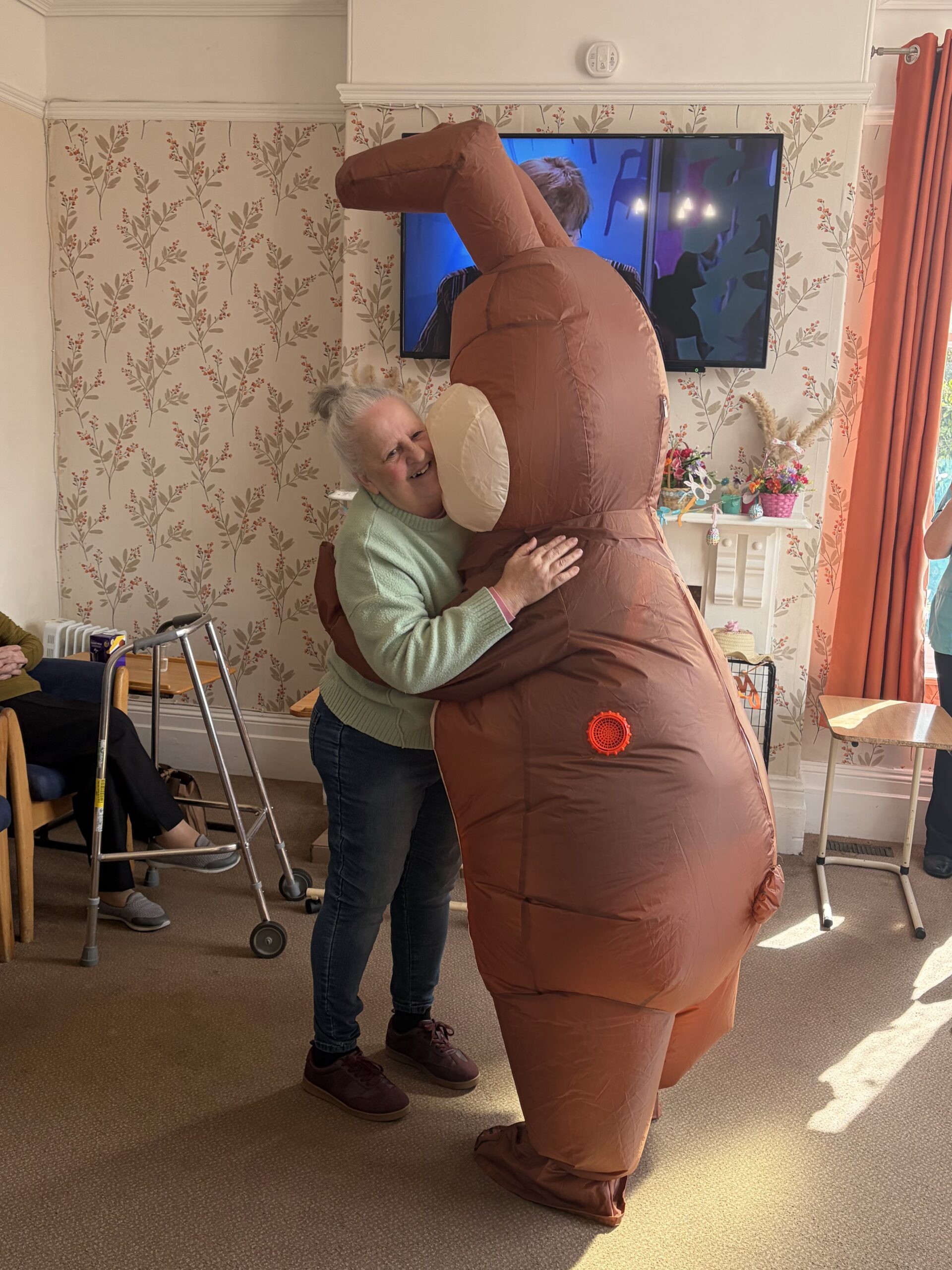 Easter bunny hugging a female resident scaled