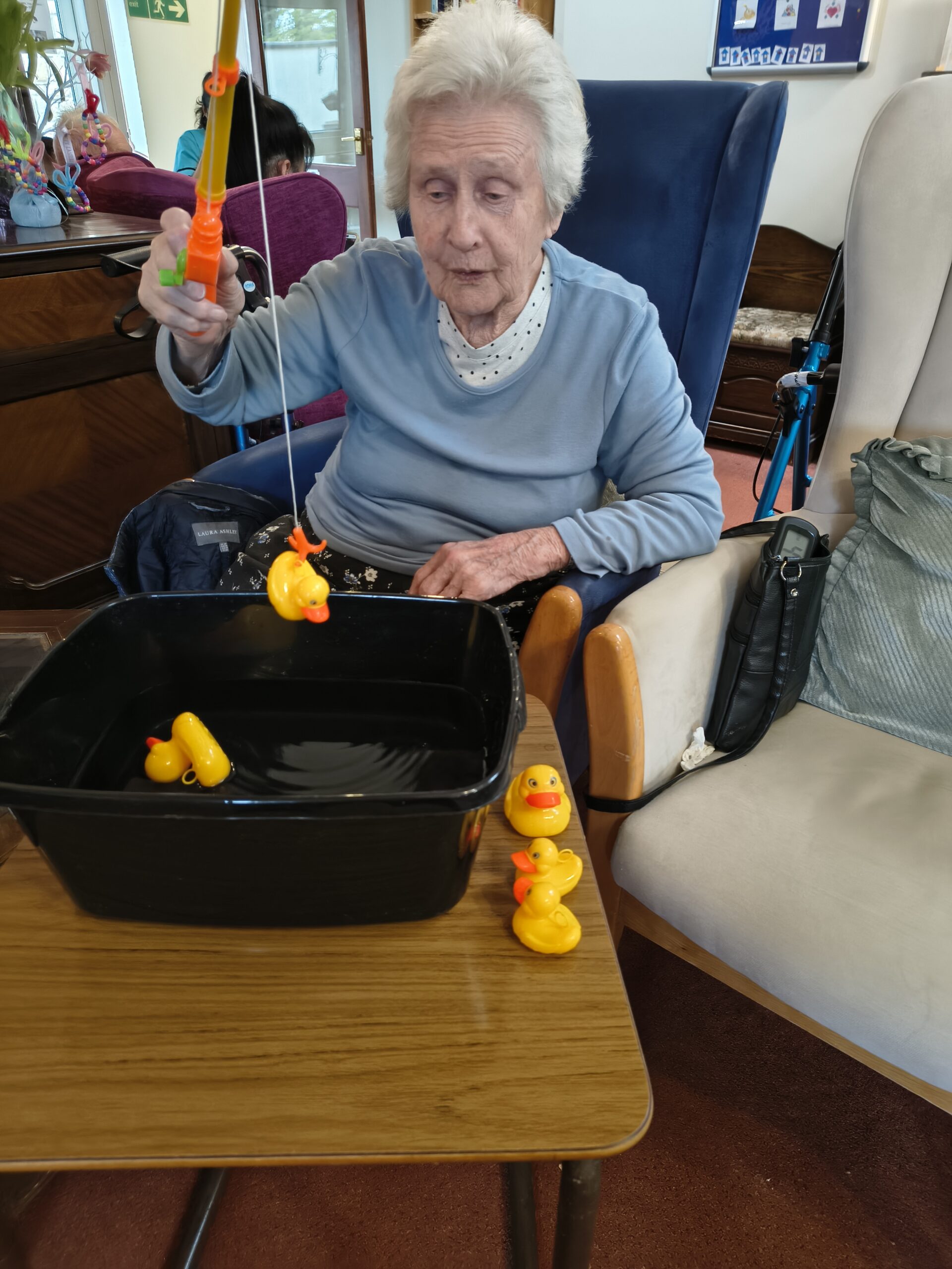 Female resident hooking her third duck from the bowl scaled