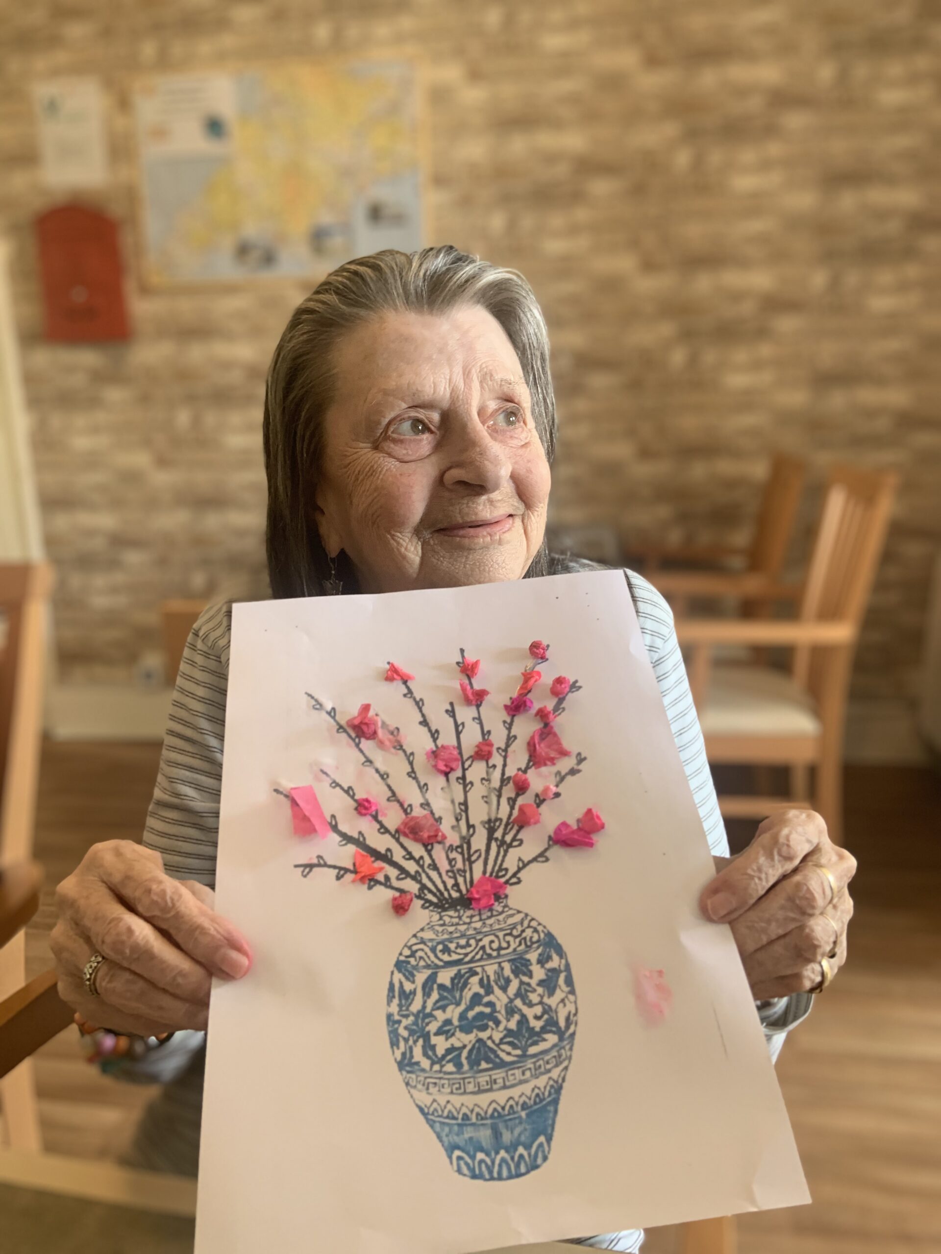 Female resident proudly showing her finished creation scaled