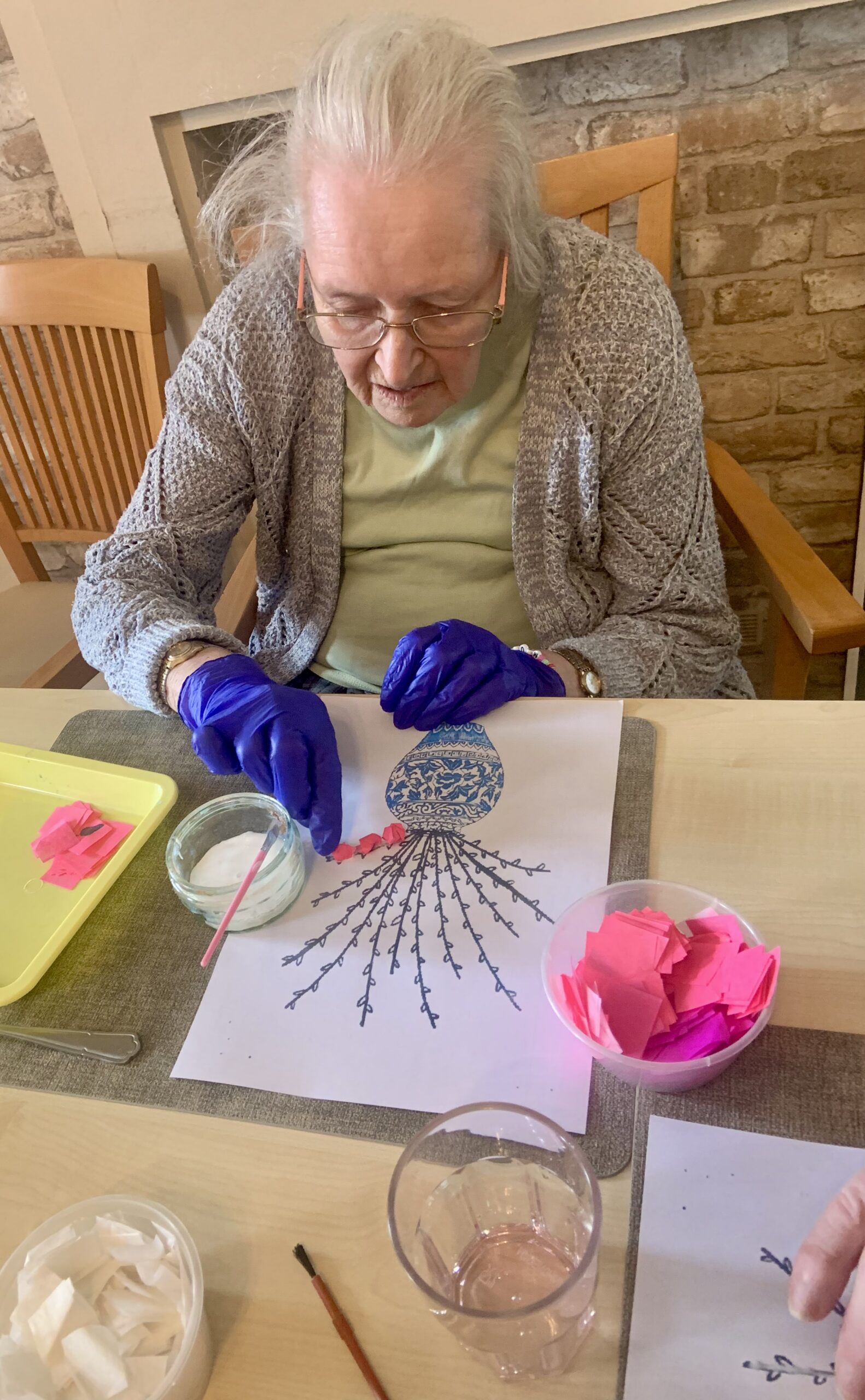 Female resident sticking her cherry blossom to the picture scaled