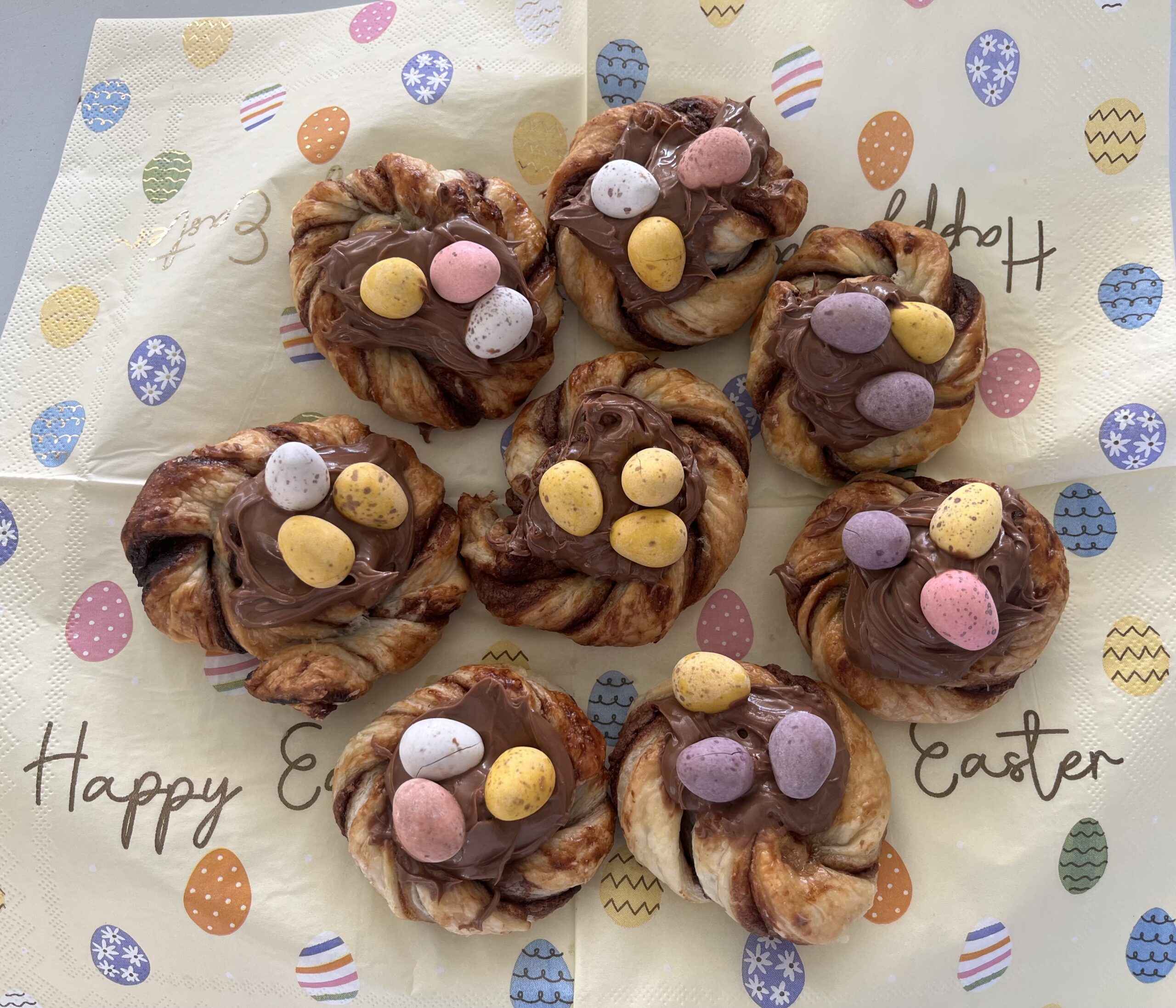 Finished puff pastry chocolate nests topped with chocolate mini eggs scaled