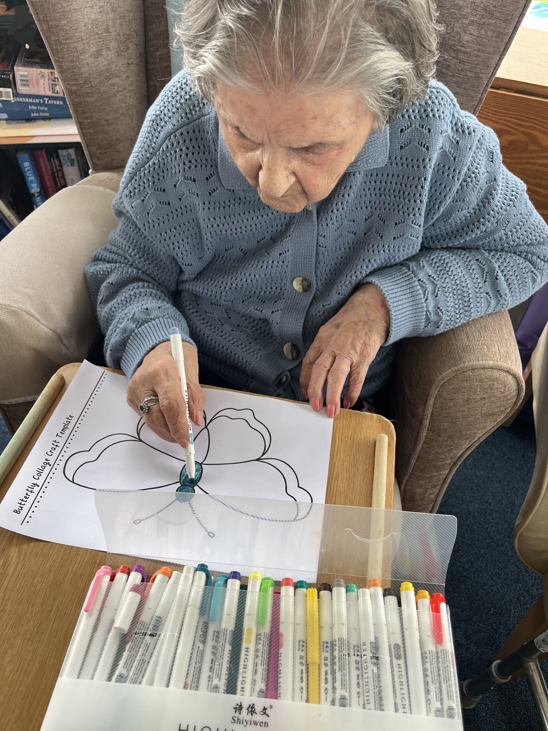 Herta colouring in her butterfly with felt tip pen scaled