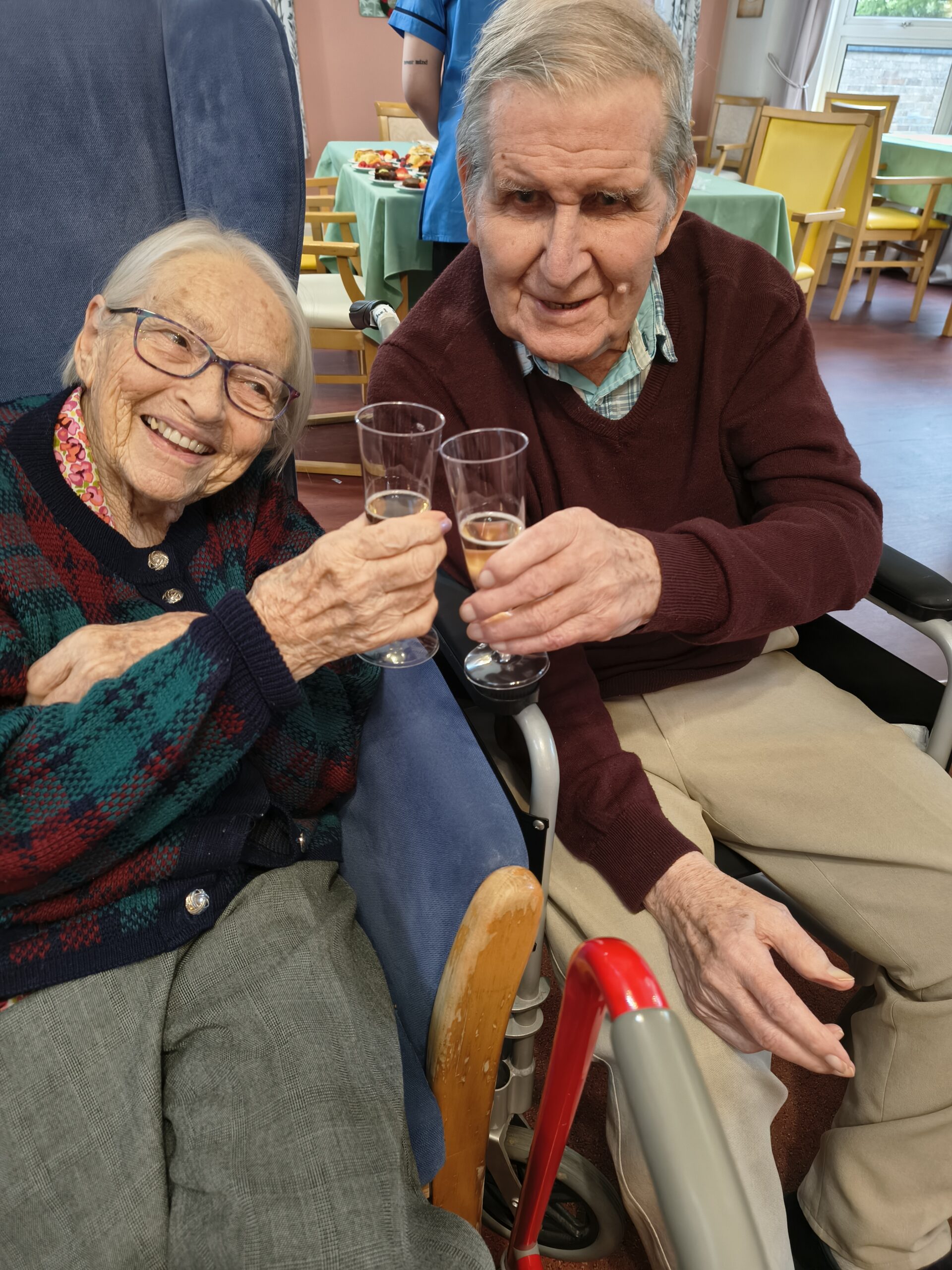 Male and female residents clinking glasses of bubbly Male and female residents clinking glasses of bubbly scaled