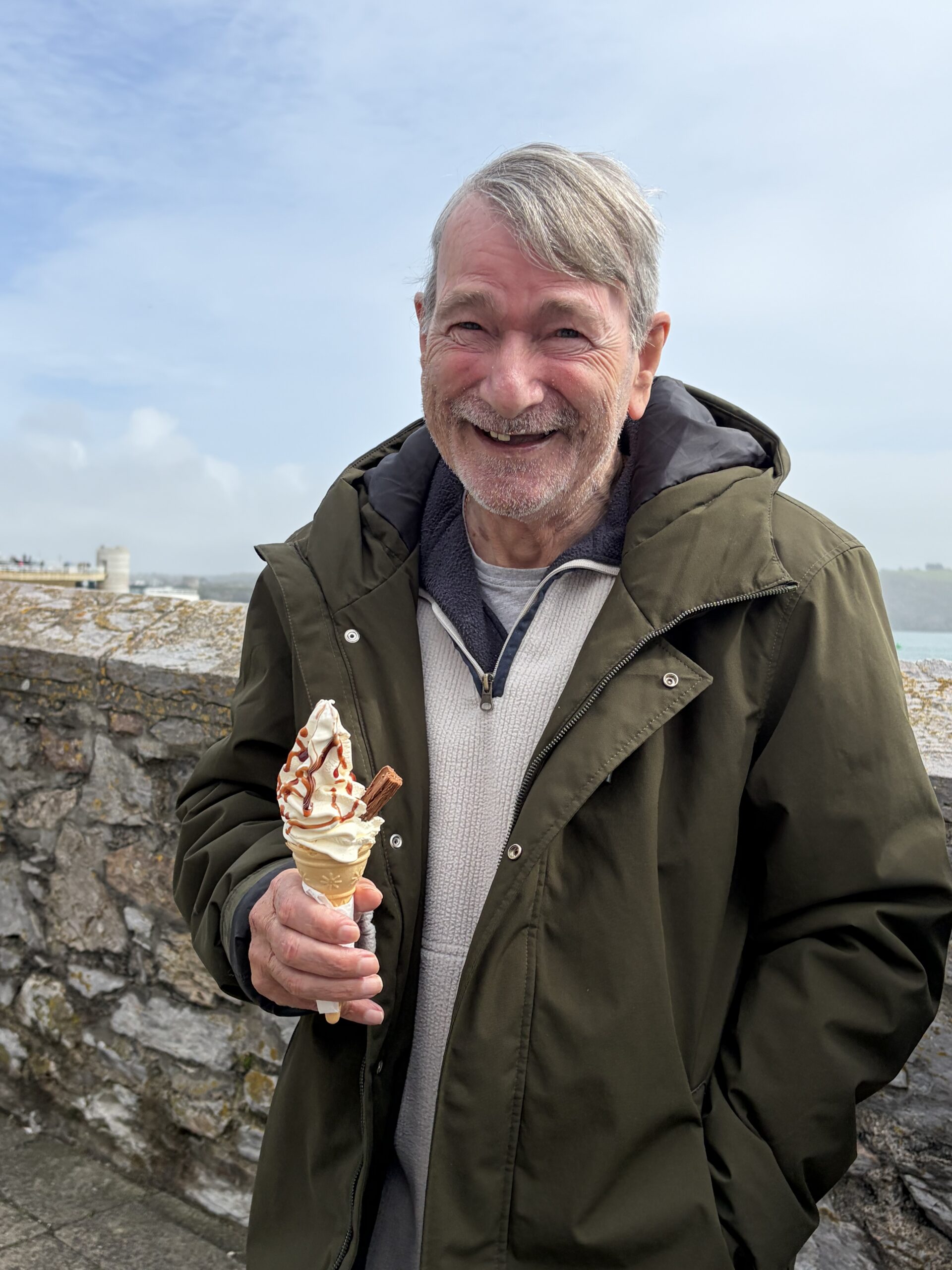 Martin holding a vanilla ice cream cone with a chocolate flake scaled