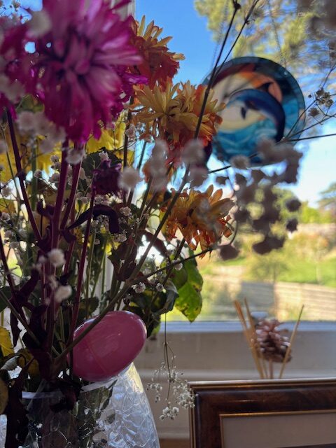Pink egg hidden in a bouquet of flowers rotated