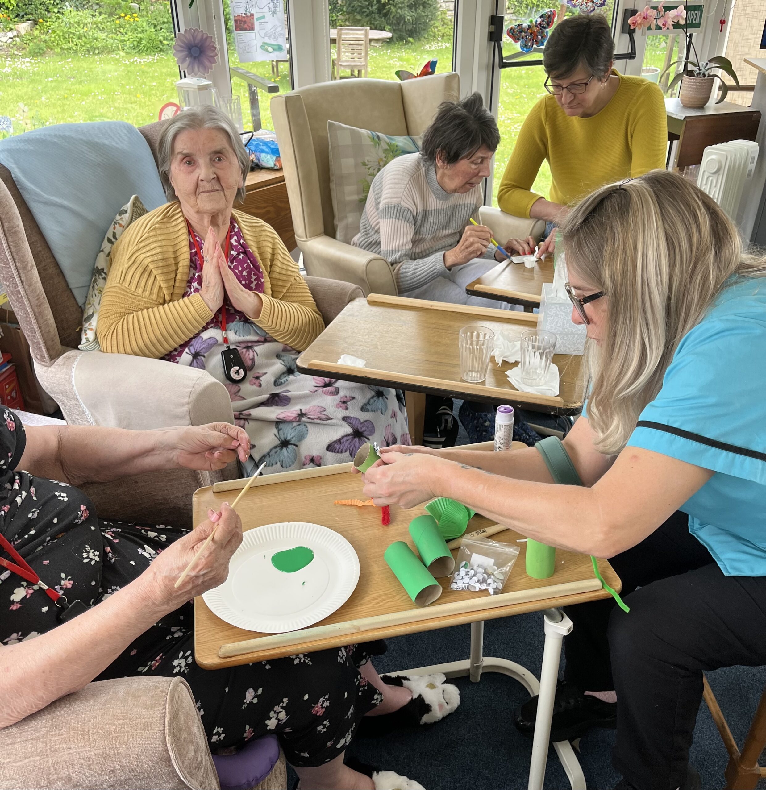Residents and carers helping each other with the task scaled