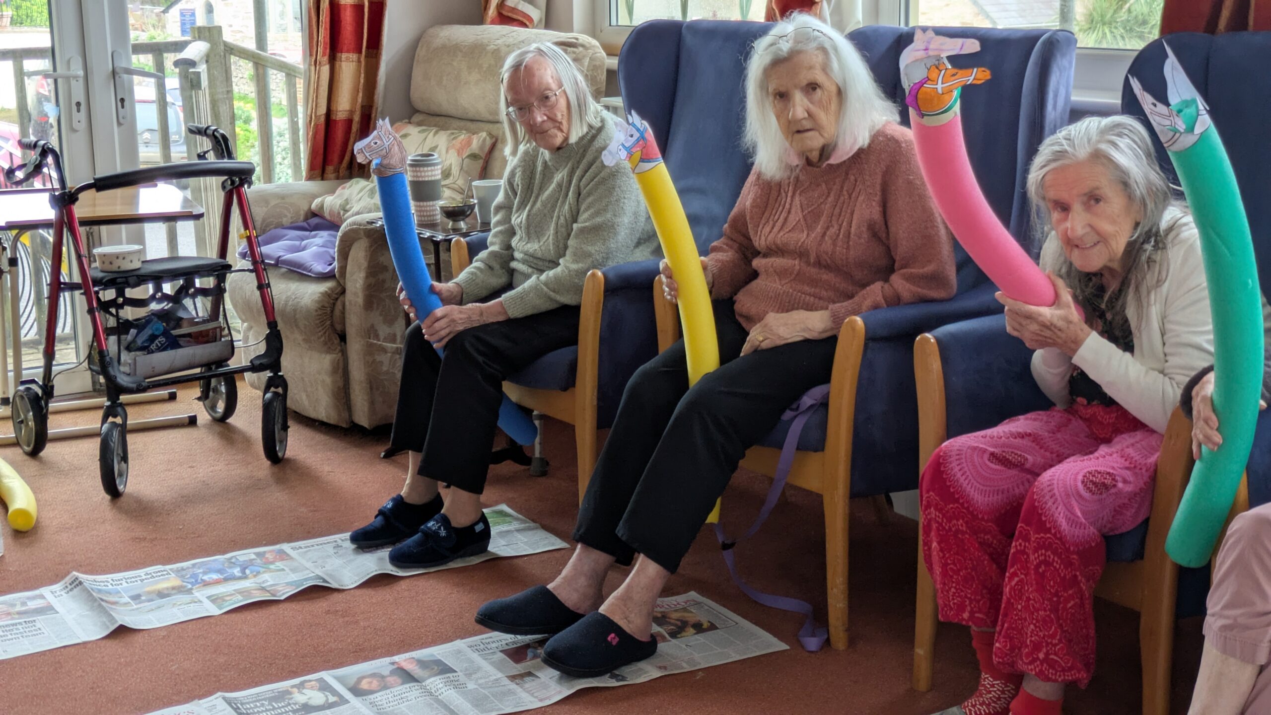 Residents holding their pool noodle race horses at the ready scaled