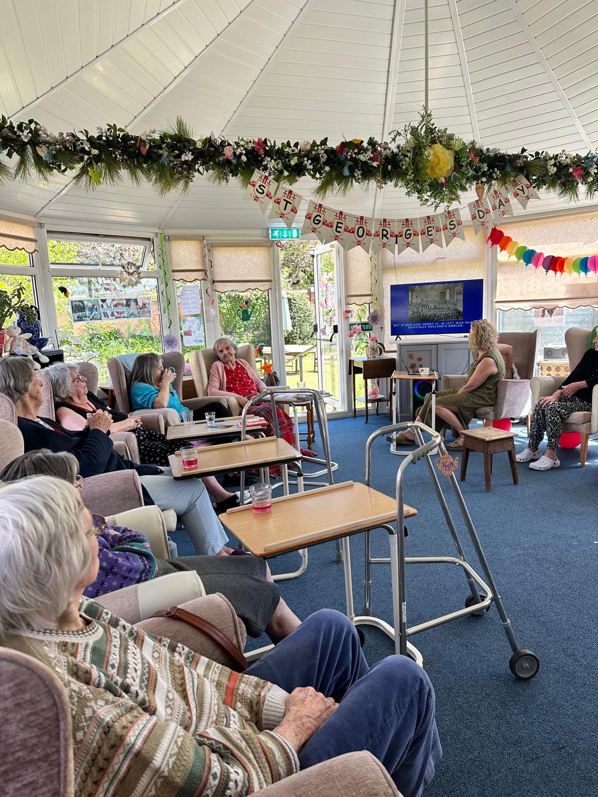 Residents seated together listening to the fun facts and quiz questions Residents seated together listening to the fun facts and quiz questions