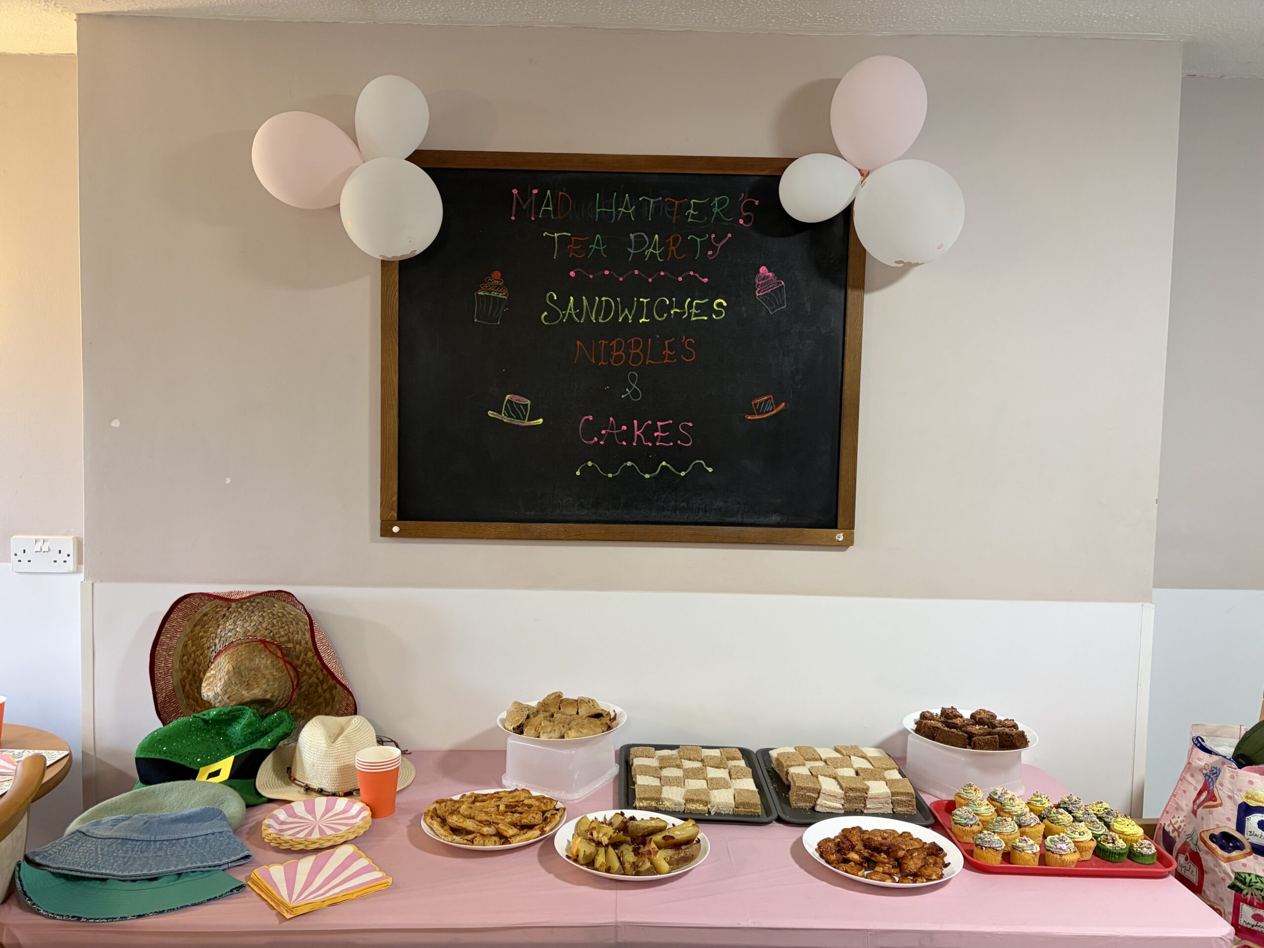 Selection of food and hats for the Mad Hatters party including checker board sandwiches scaled