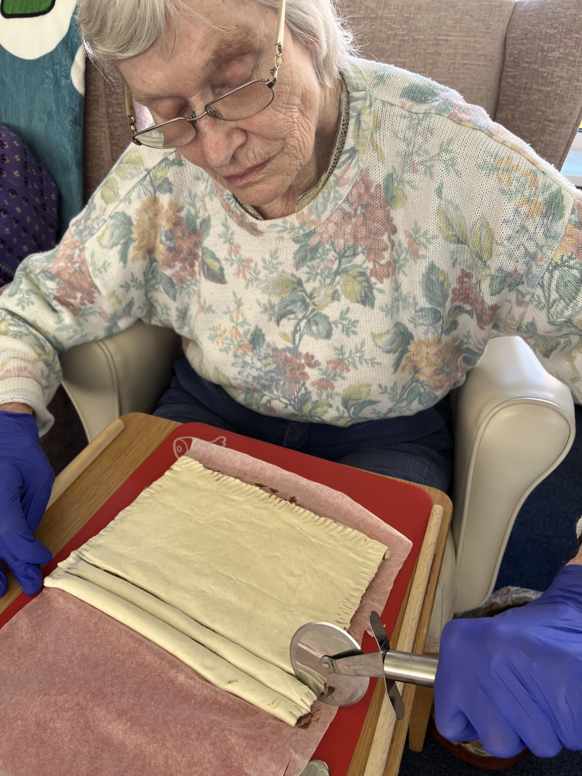 Wendy cutting chocolate filled pastry into strips scaled