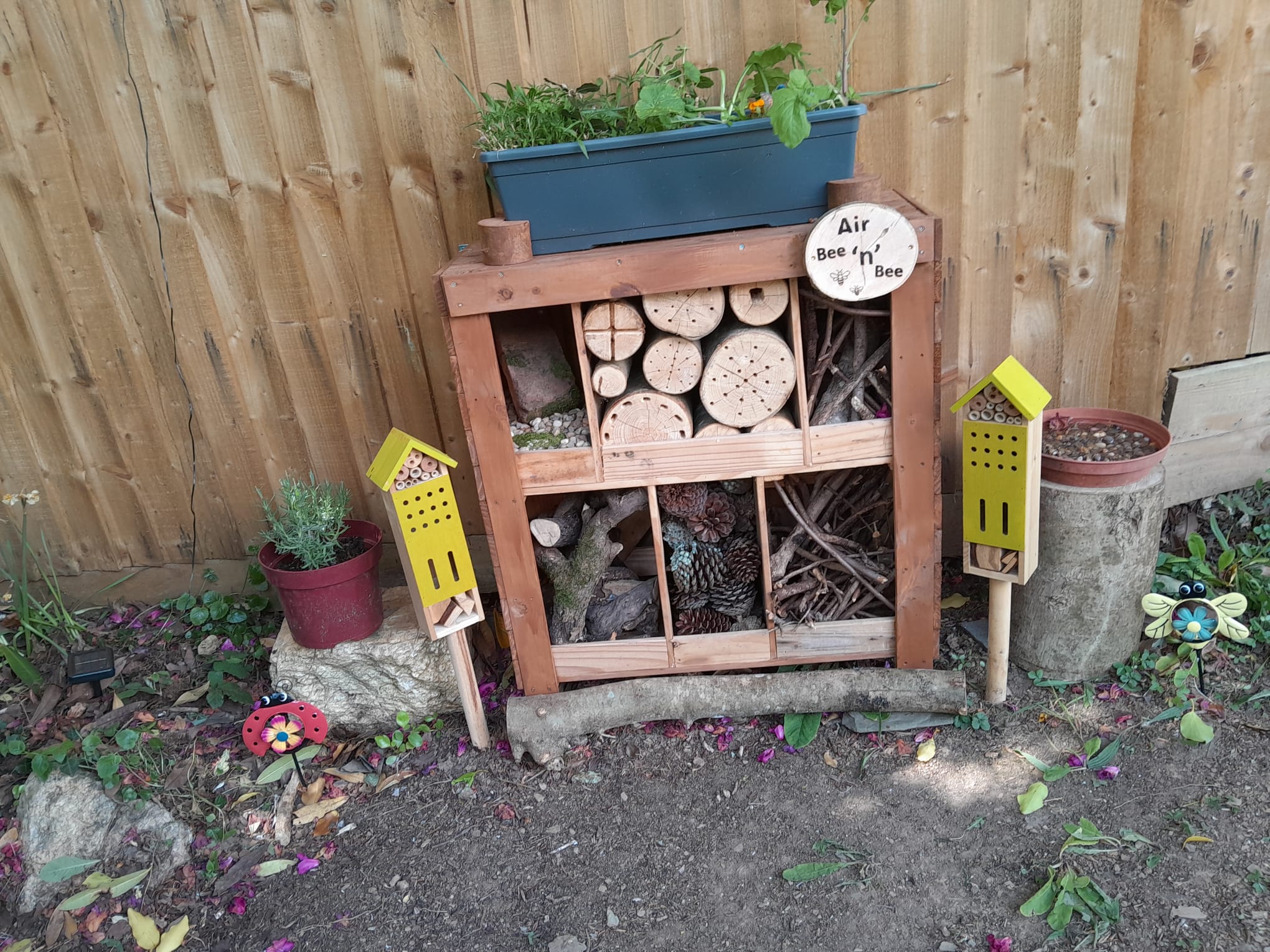 Air Bee n Bee in full with logs and sticks pine cones and stones for insects to live in