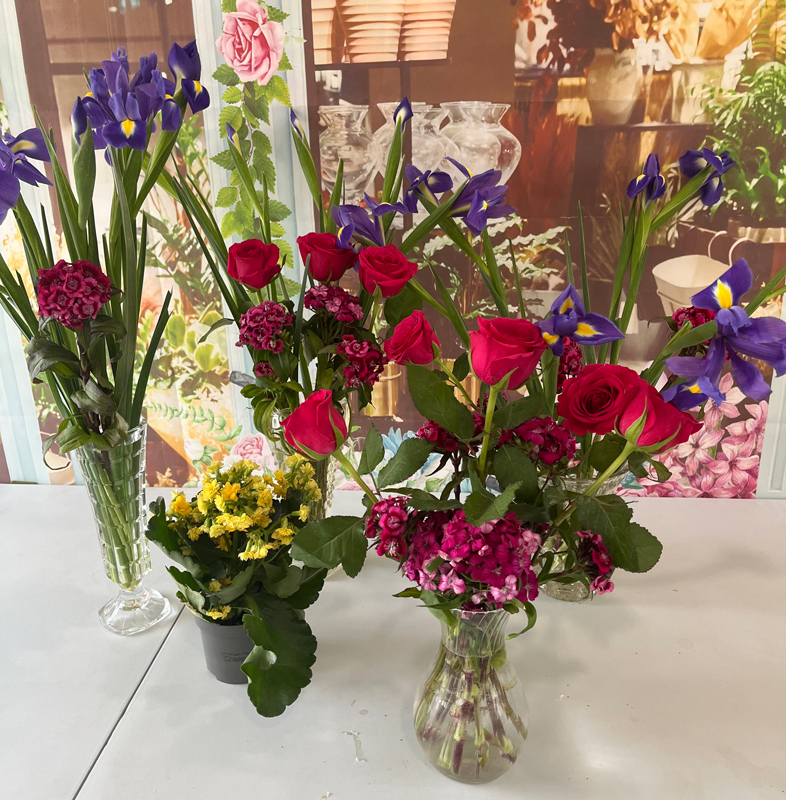 All the flower arrangements together on a table ready for display