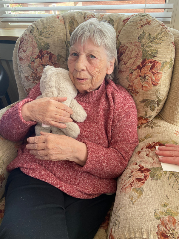 Ange cuddling the toy kitten