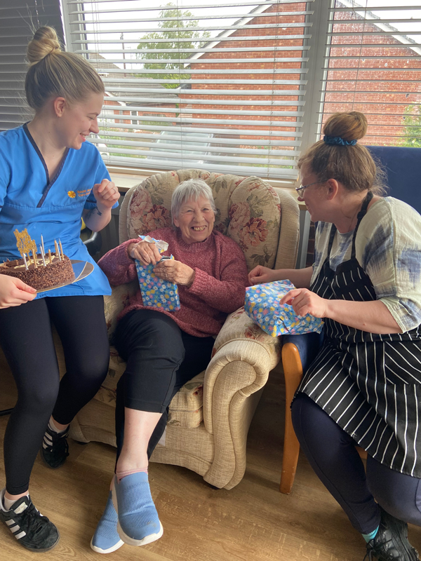 Ange opening more presents with Katie and another colleague