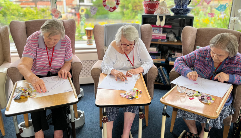Barb Maggie and Herta seated together working on their patchworks