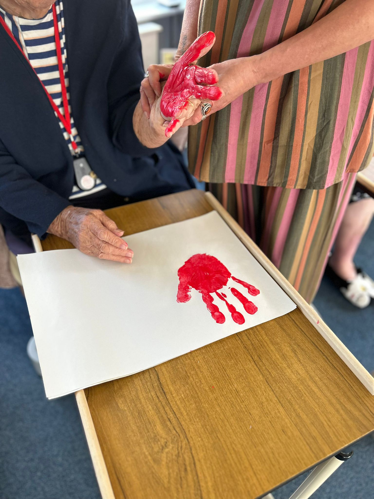 Barb doing her red paint hand print