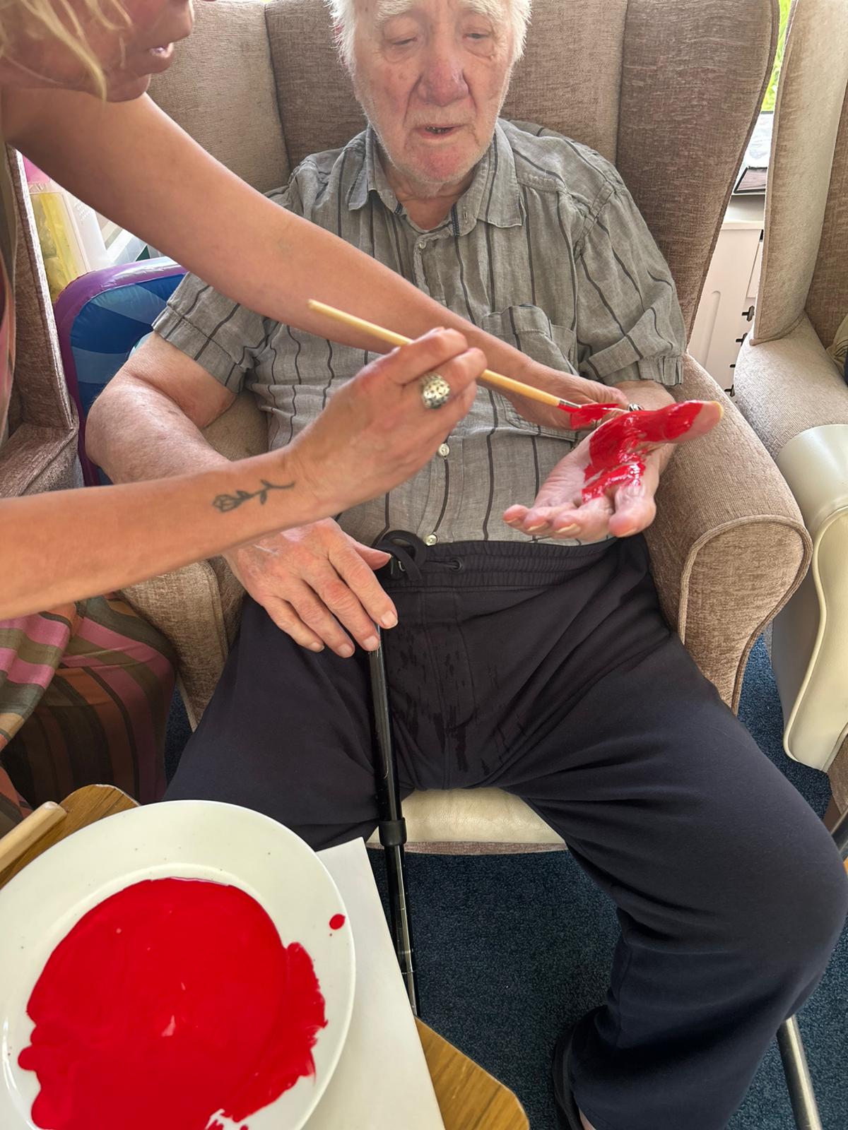 Bill having his hand painted red ready to print