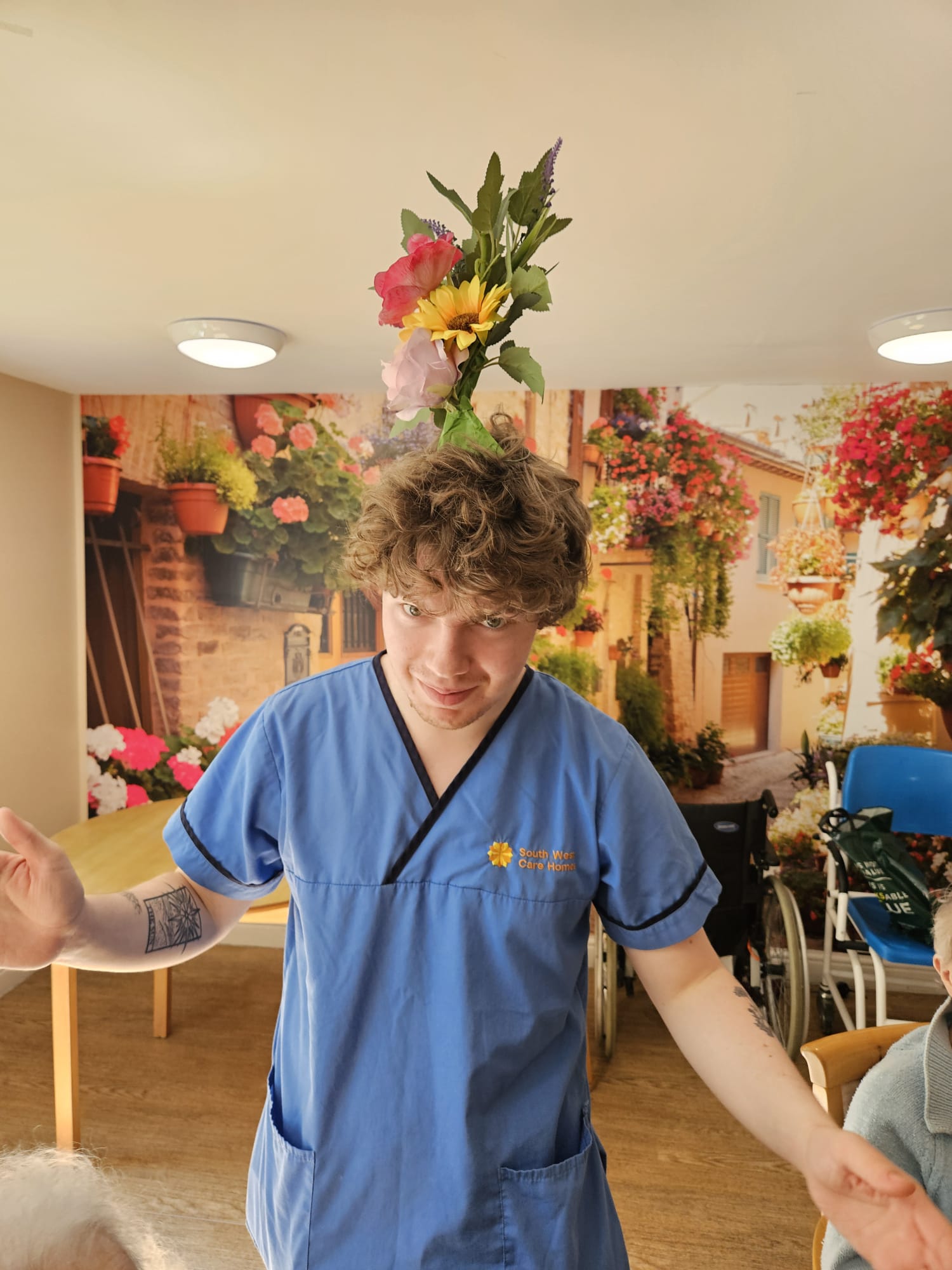 Carer Owen with a finished wreath on his head 