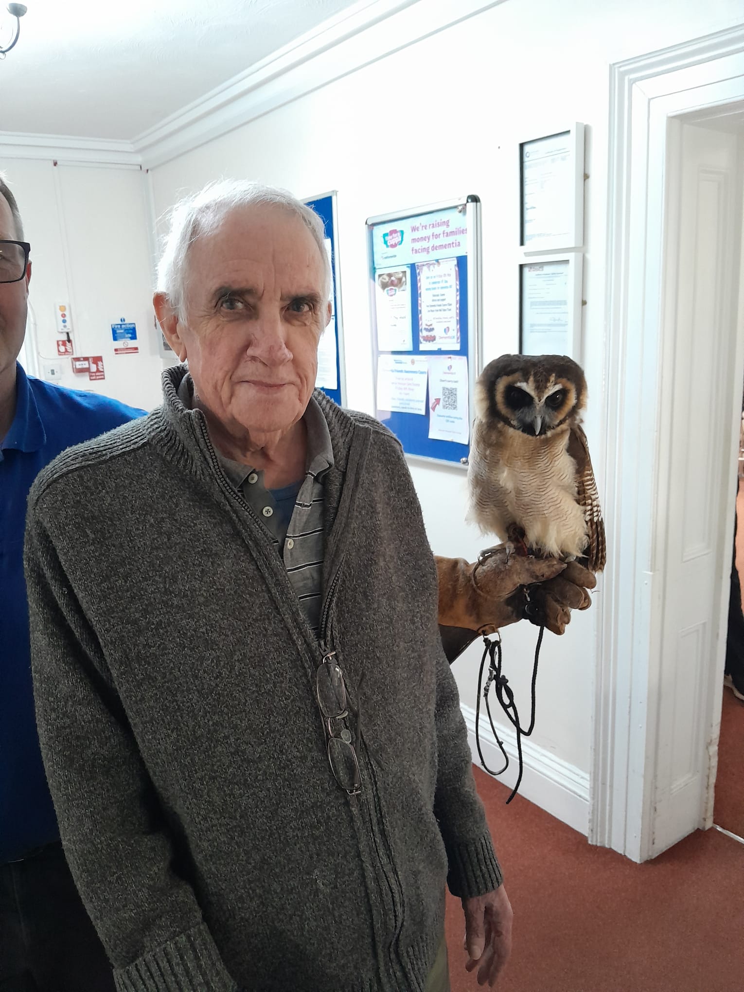 David stood beside Bill the Owl smiling for the camera