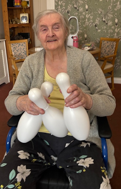 Doris female resident holding pins laughing