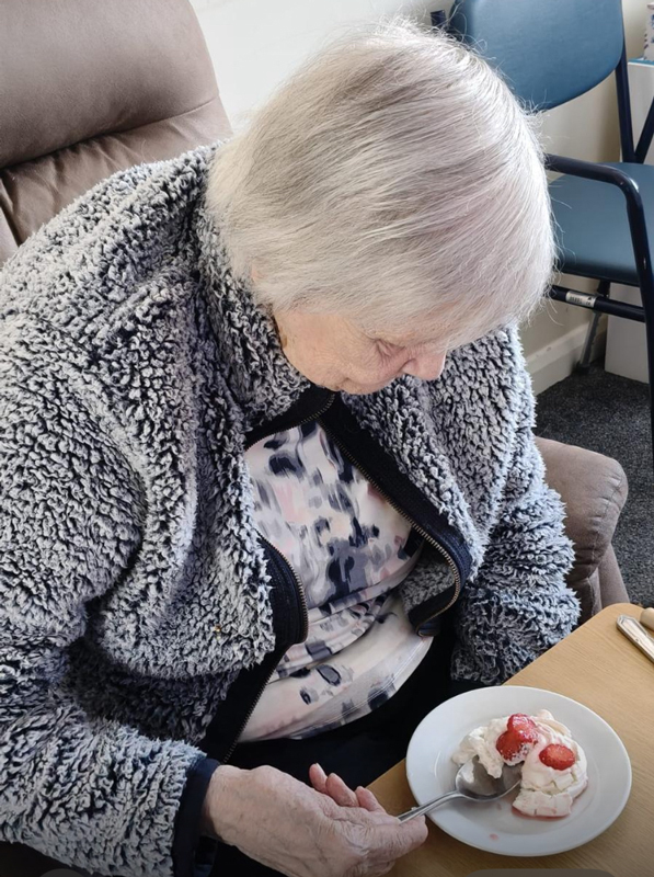 Female resident about to tuck in to a pavlova