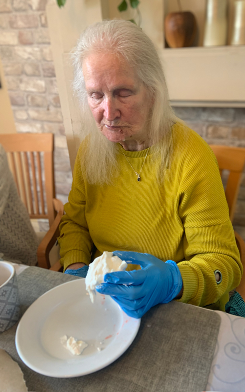 Female resident eating a pavlova