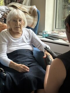 Female resident having a hand massage rotated
