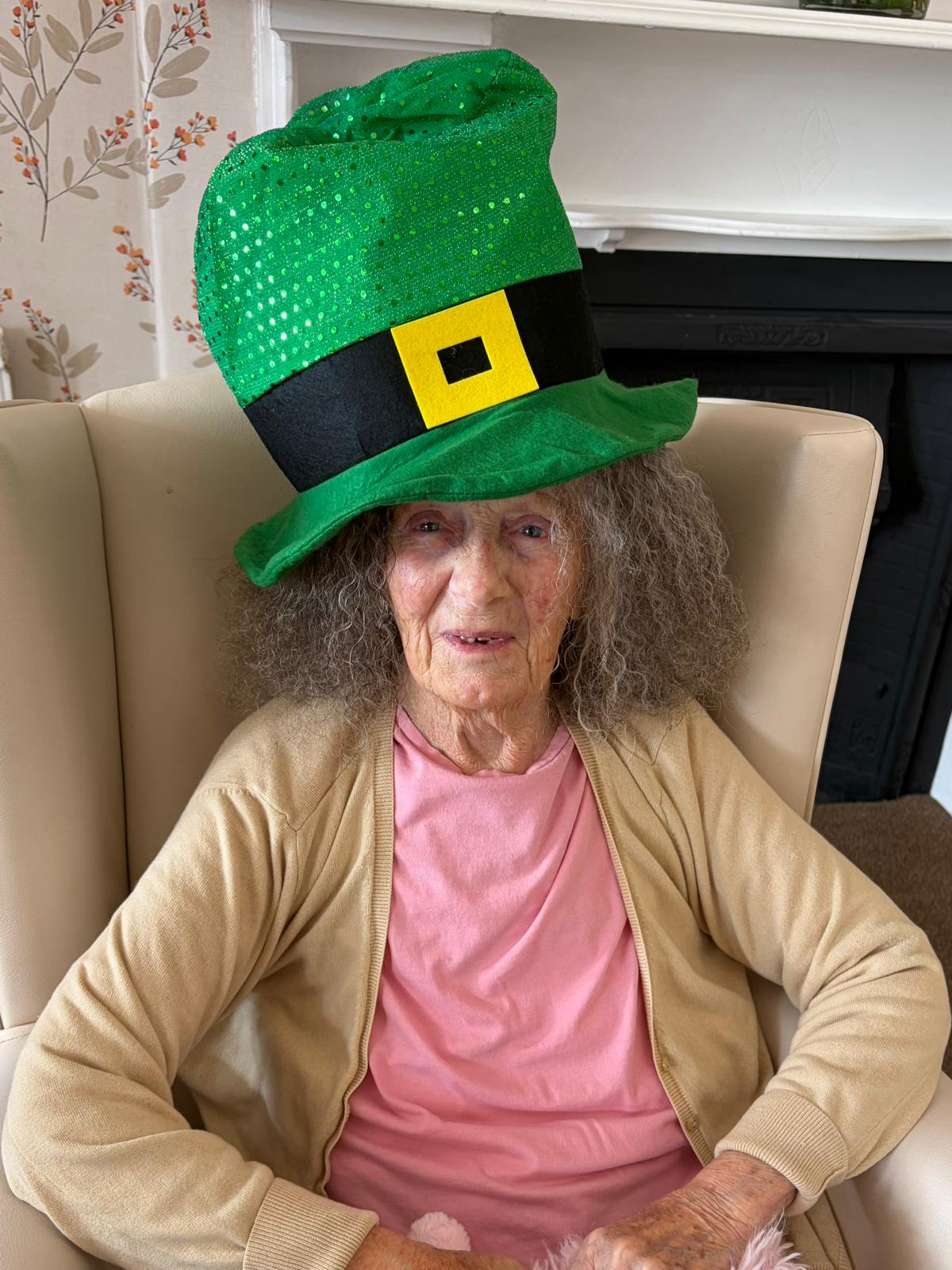 Female resident smiling in her leprechaun hat