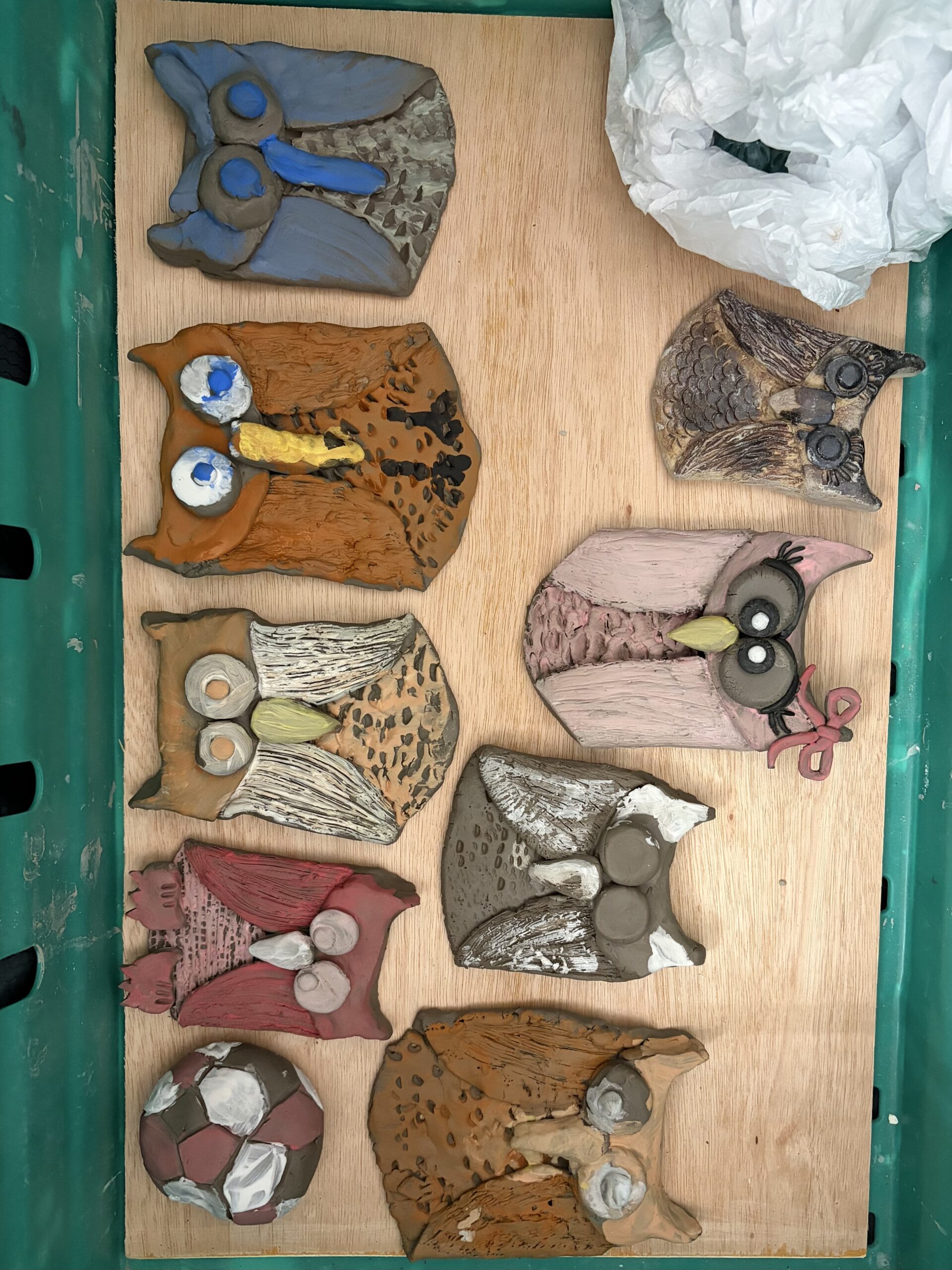 Finished clay owls of various colours shapes and sizes scaled