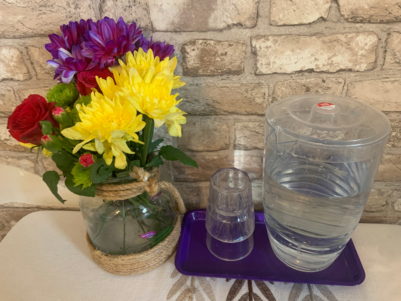Finished displays of flower filled vases around the care home 1