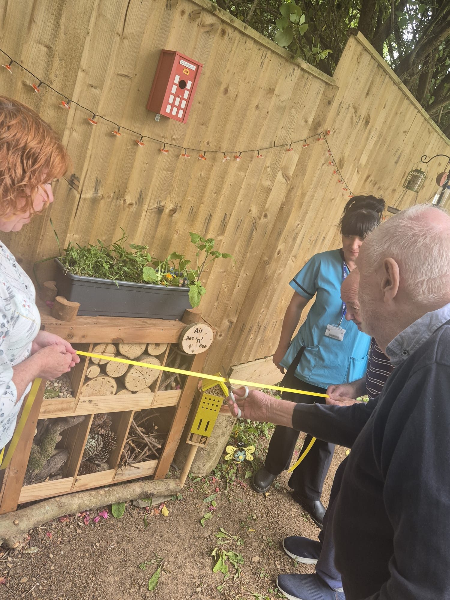 Ivor cutting the ribbon to open the Air Bee n Bee