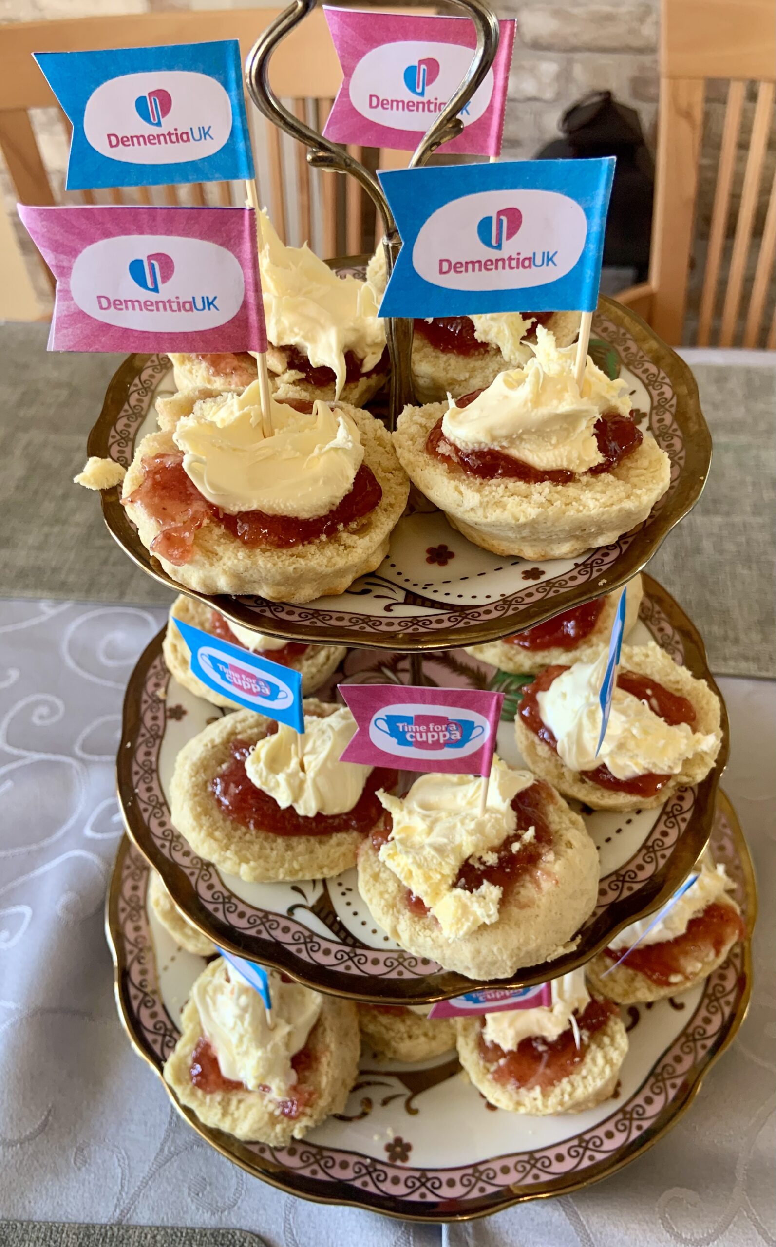 Jam and cream scones arranged on a 3 tier cake stand scaled