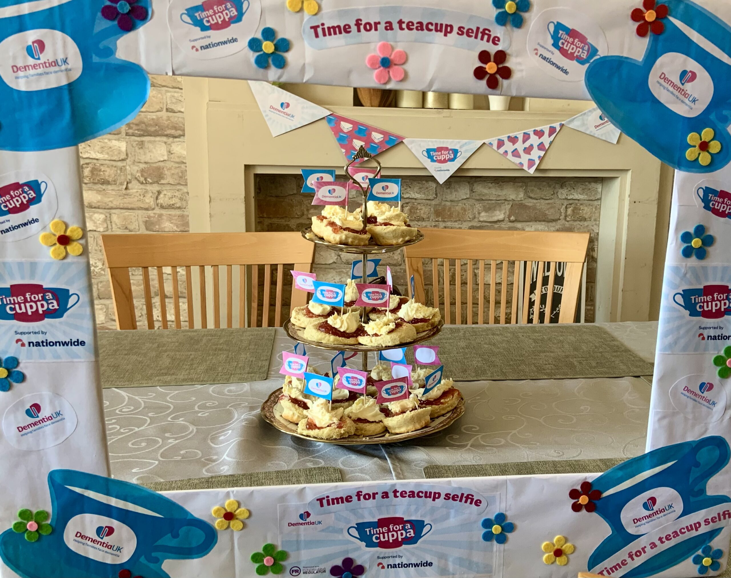 Jam and cream scones arranged on a 3 tier cake stand with Time for a Cuppa picture frame scaled