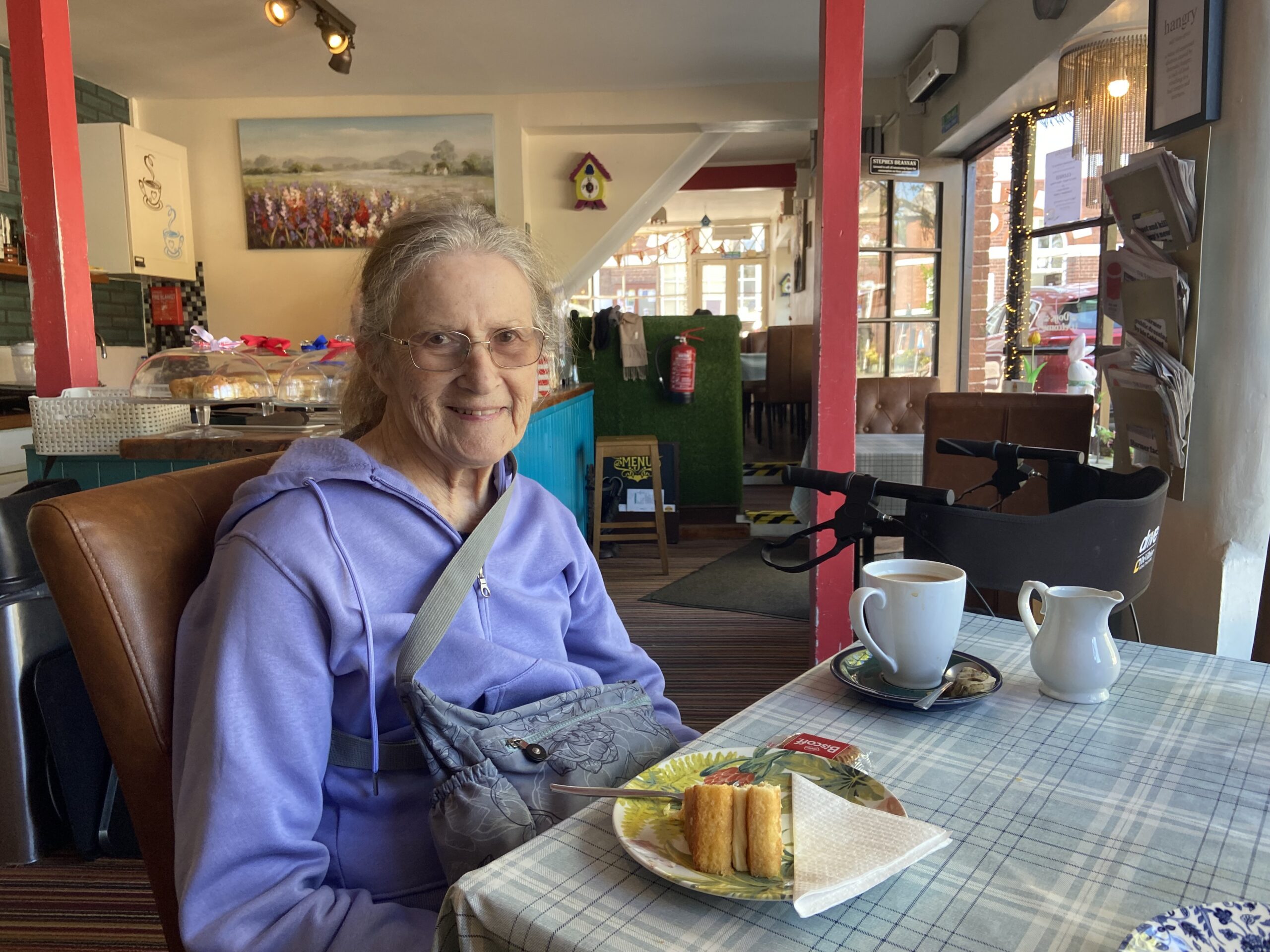 Lesley seated in a teashop cafe with a piece of lemon drizzle cake Lesley seated in a teashop cafe with a piece of lemon drizzle cake scaled