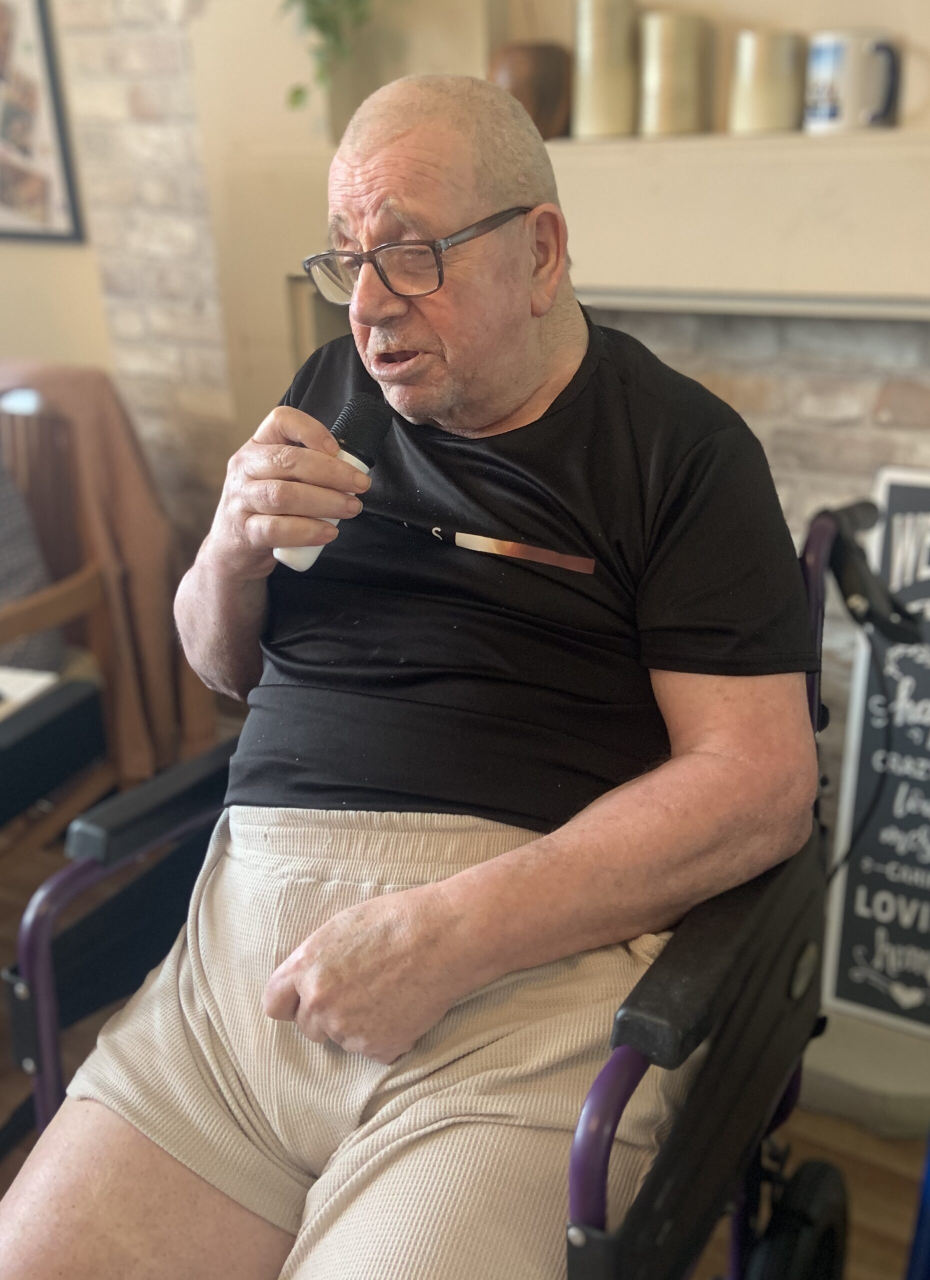 Male resident singing into a microphone 1 scaled