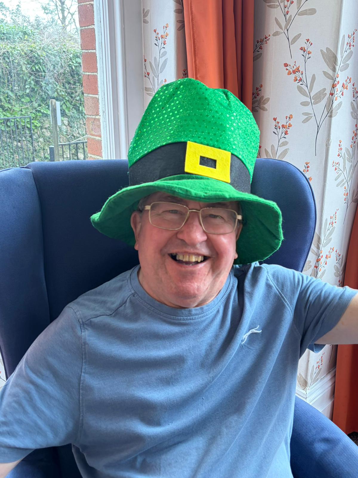 Male smiling wearing a leprechaun hat