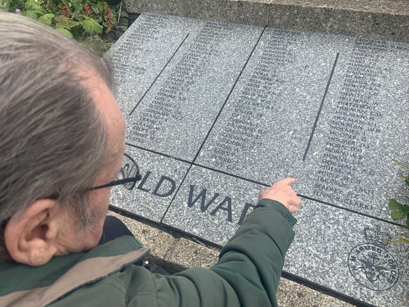 Maurice at the War memorial intern pointing at names