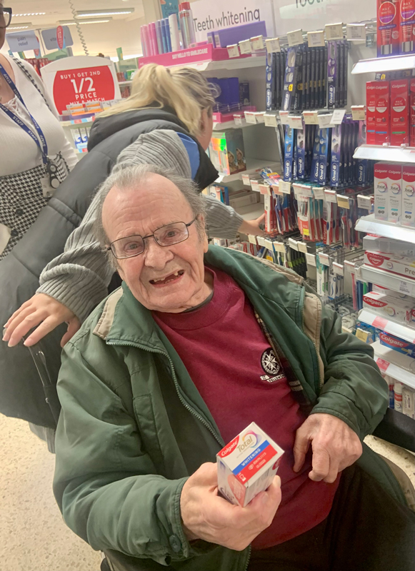 Maurice in a supermarket holding toothpaste