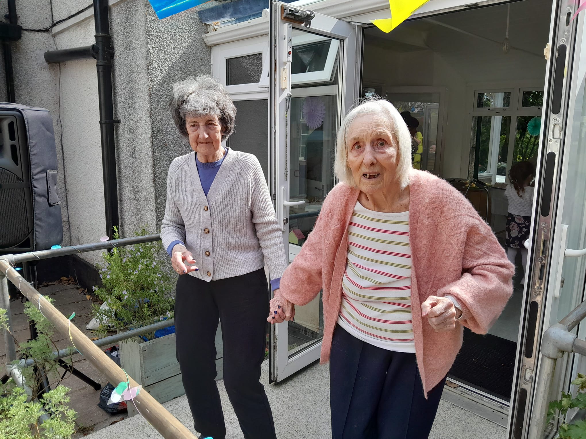 Muriel and Jean hand in hand dancing