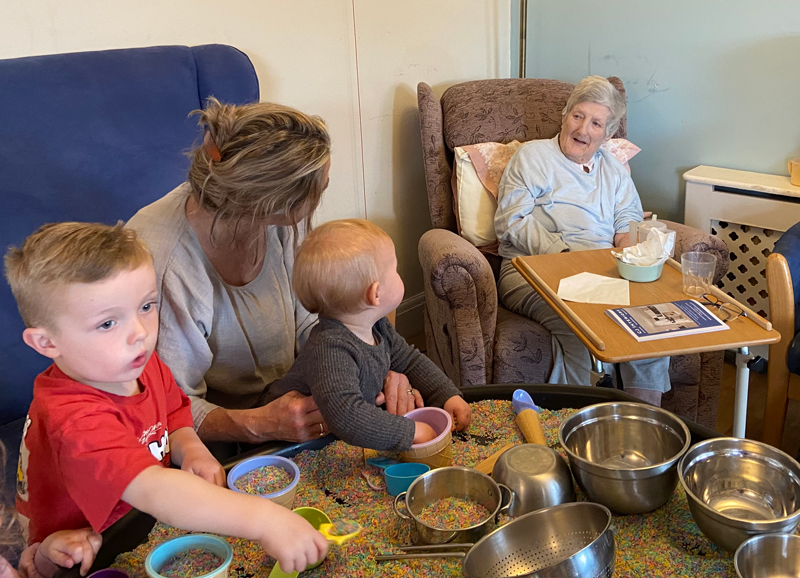 Pam chatting with Claire as the children play