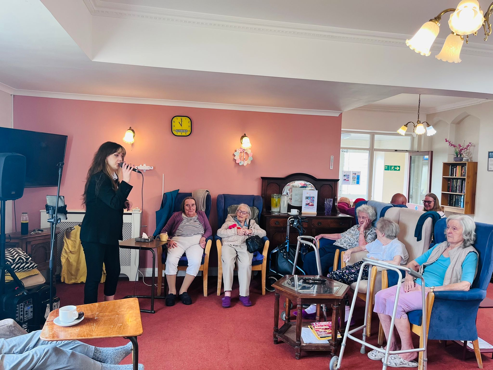 Residents all seated watching a lady singing