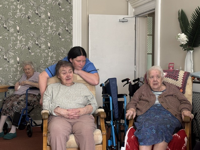 Residents and carer enjoying the music