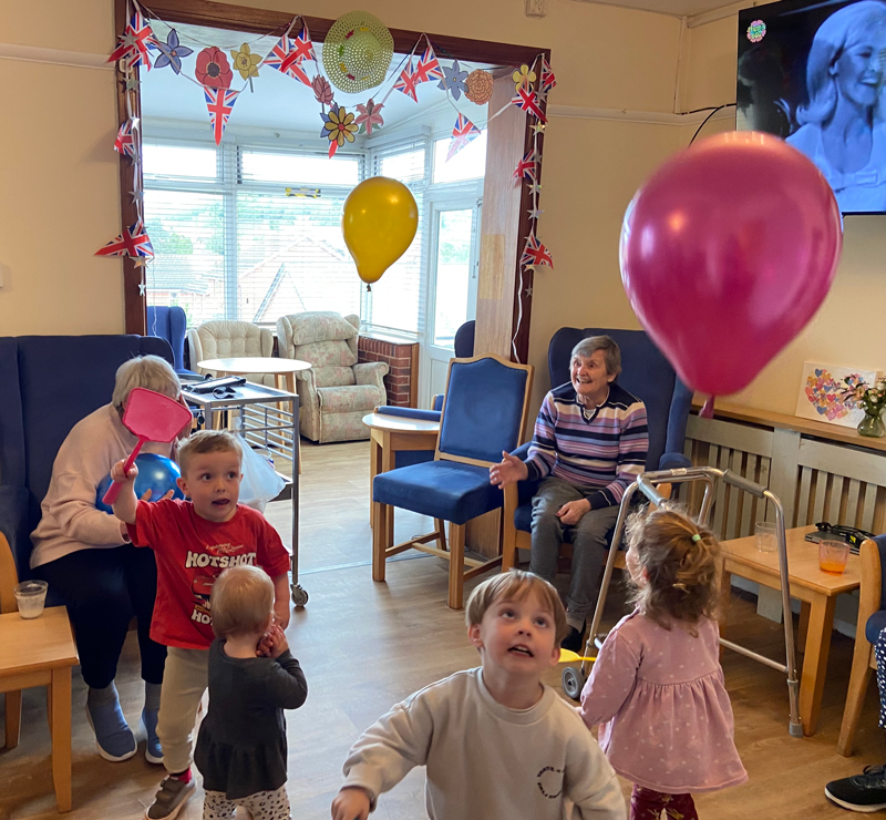 Residents and children playing with balloons