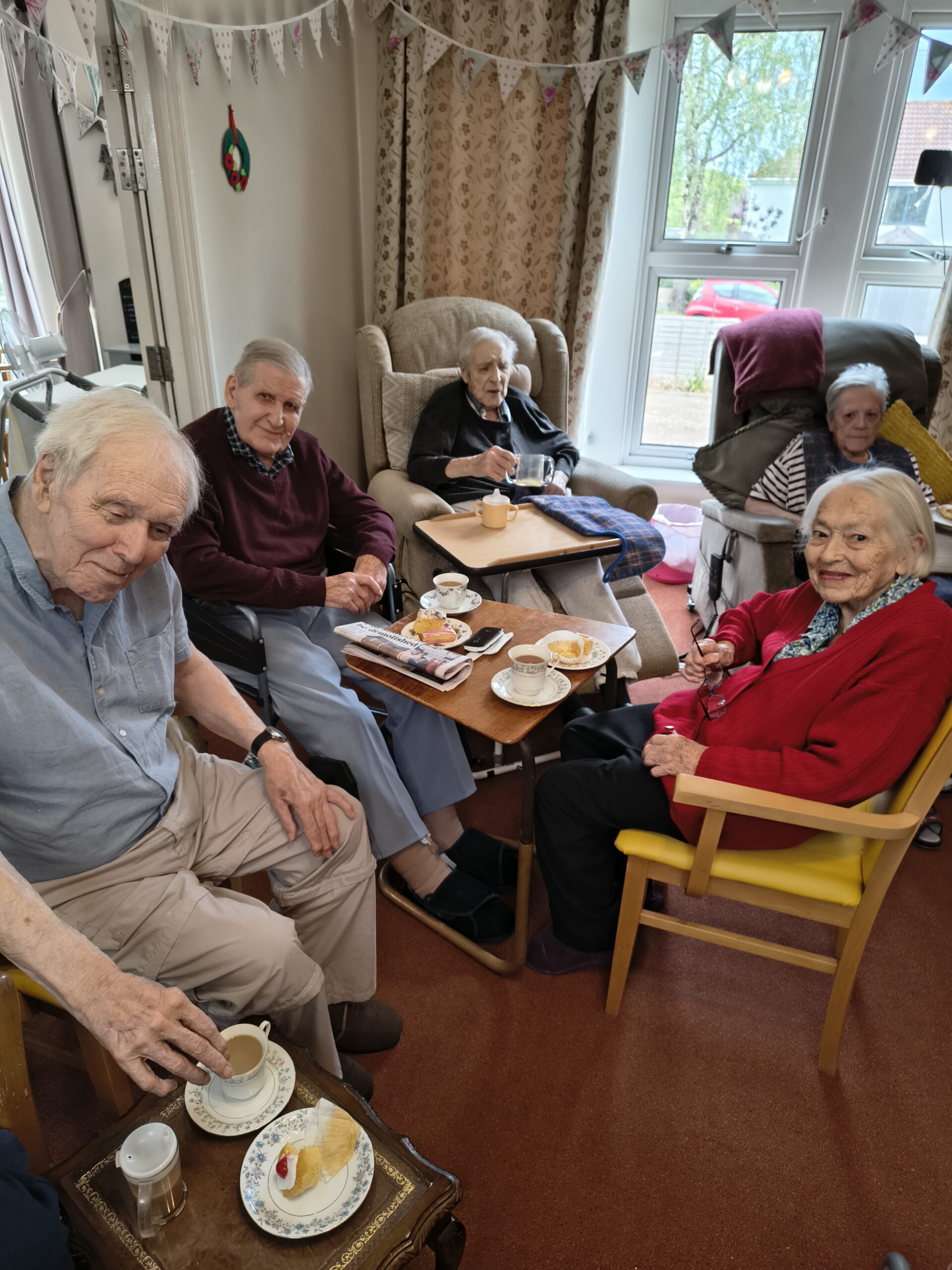 Residents enjoying tea and cake together scaled