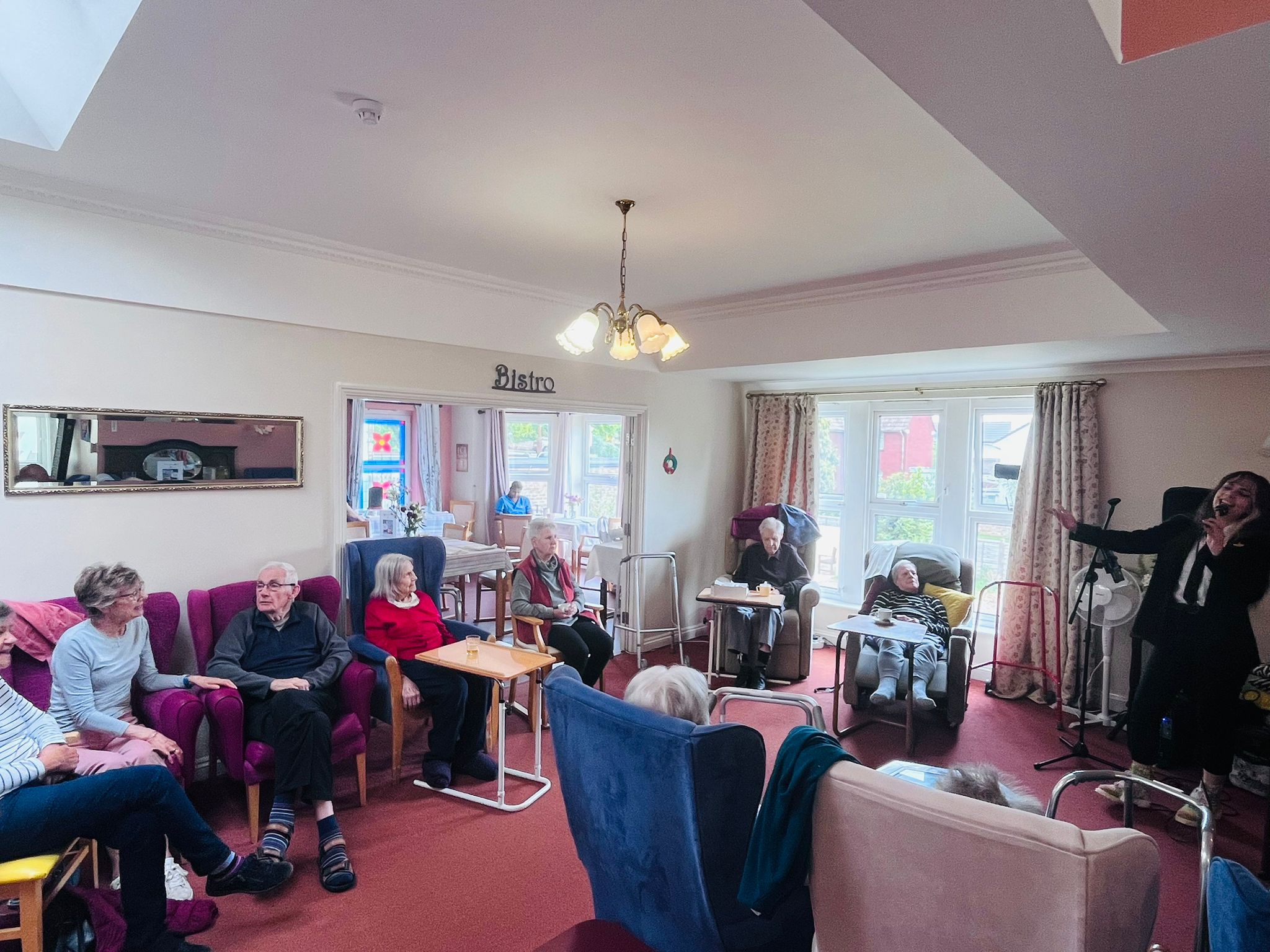 Residents enjoying the performance of a lady singing